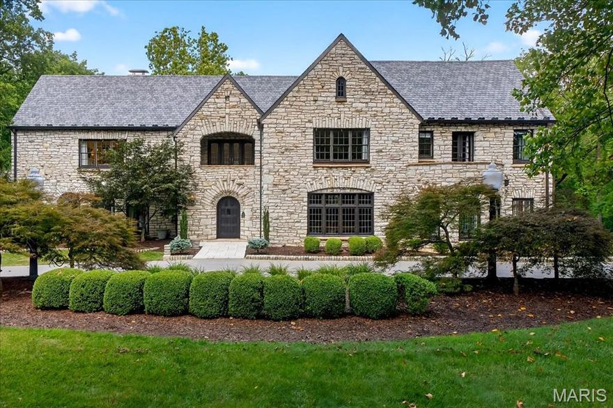 This unparalleled Ladue Estate on highly esteemed Dromara Road, evokes the dream life from the moment you arrive. The property’s Grand Presence is immediately felt—Manicured Gardens frame the striking facade of Missouri church stone, while the architecturally commanding roofline is constructed from newer slate-synthetic materials, blending timeless elegance w/ durability. Every angle of this home captivates, as period architecture blends effortlessly w/ Modern Luxury. The main level is designed for Grand-Scale entertaining & intimate everyday living. Rich wood floors, leaded glass windows & custom millwork speak to the home's craftsmanship. The formal dining rm feat a wine cellar & butler’s pantry w/ rare onyx counters. A sunken living room flows into a stone-clad sunrm w/ patio access—ideal for seamless indoor-outdoor living. The luxury chef's kitchen opens to a vaulted family rm w/ fireplace & built-ins. 2 offices/dens & laundry rm complete the main. A sculptural staircase leads to the 2nd flr, where you'll find 2 Gracious Primary Suites & 2 additional bedrooms—each w/ en-suite baths. The Brand-Newly Finished LL adds 1,866 sqft: 2 bedrms, 2 full baths- 1 w/ laundry, workout rm, family rm & a Show-Stopping bar—ideal for entertaining. Outside, terraced patios lead to a Resort-Style backyard w/ Pool & Pool House. Situated on nearly 4.5 acres, this property offers Rare Privacy, idyllic forest, a winding creek & space for play or exploring nature.