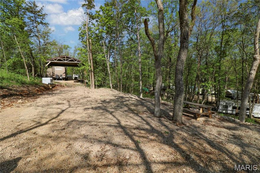 Opportunity to own 4 corner lots in beautiful, Cedar Lake where you can camp, fish, kayak, swim and enjoy the outdoors.  Vacation property is partially graded and ready for your RV including a camper electric box and freshwater tank. Cedar lake is a private gated community located approximately one hour south of St. Louis. Create your own outdoor oasis!