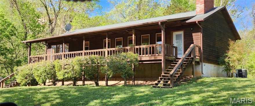 Beautiful spacious riverfront home completely remodeled approximately 8 years ago.  This home has an open concept living room/dining room and kitchen that provides a comfortable, yet elegant atmosphere.  5 spacious bedrooms, two bathrooms, and a large laundry room will be great for all your friends or family that visit.  There is a massive garage area under the home to store your boats, kayaks, rafts, and a few vehicles as well.  If it is raining, you have no worries, the covered concrete patio will be the place to hangout and grill with your visitors. On the cool fall evenings you can gather around the concrete firepit area making memories that will last a lifetime.   Three of the bedrooms are walk out, 2 of them leading  onto the porch.  The property lays on both sides of Carter 103 and includes 100' of Current River riverfront where you can install your own private boat dock . The property is part of the Bass Rock LLC. with private boat ramp and river access.  Located above the bridge in Van Buren this home has a gorgeous view and a porch swing to enjoy the floaters and boaters passing by.   You will find every season enjoyable from the spectacular view of your full length front porch.   The amenities of local shopping, dining and sight seeing are just minutes away.  This home won't last long, so schedule your showing today.  Photos should be available later today and will be added once received.