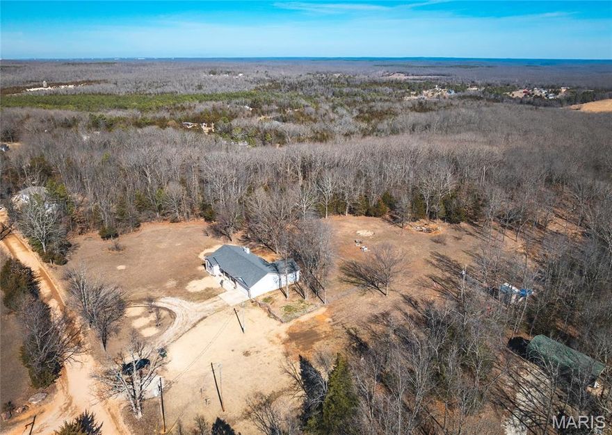 Discover the perfect blend of space, comfort, and serene country living with this beautifully maintained 3-bedroom, 2-bath home offering 1,588 sq ft of thoughtfully designed living space, plus a full unfinished basement with an additional 1,588 sq ft—ideal for future expansion, storage, or a workshop. Conveniently located just minutes from Fort Leonard Wood, this property provides both privacy and accessibility. Step inside to an inviting open floorplan accented by vaulted ceilings and abundant natural light. The spacious living room features a cozy wood-burning fireplace, creating a warm and welcoming atmosphere. The kitchen is a standout, offering stone countertops, ample cabinetry, and plenty of workspace—perfect for everyday living and entertaining alike. The primary bedroom is impressively large, providing a true retreat, while the second and third bedrooms are generously sized as well. A brand-new, high-quality Rheem heat pump installed in 2025 ensures efficient, year-round comfort. Situated on a picturesque 3-acre parcel, the property offers peaceful, serene surroundings with a healthy deer population frequently passing through. The fenced-in backyard is ideal for pets, play, or outdoor gatherings, and the circle driveway adds both convenience and curb appeal. An additional 12.27-acre parcel is included, featuring abundant wildlife activity and making it an excellent option for hunting or recreational use, with electric and water service available—offering incredible potential for future use, expansion, or investment. This property delivers space, privacy, modern updates, and proximity to key amenities—a rare opportunity you won’t want to miss.