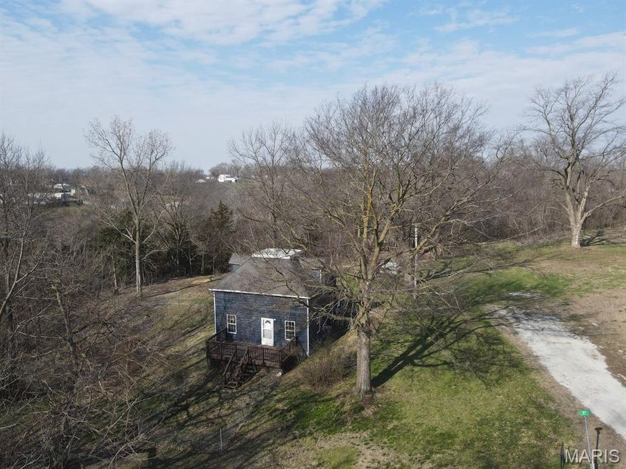 Enjoy the room here!  Nearly 5 acres on the edge of town, this wooded tract offers fenced pasture, garden spot, secluded timber, and a very well-kept home ready for its new owners.  You'll appreciate all of the updates here - the home was completely renovated starting in 2012, furnace, a/c & water heater new in 2021, shingle roof in 2012 and exterior paint just last year.  The interior was completely updated and you'll love the open kitchen/dining space, cozy living room and large master suite with walk-in closet.  There is room on the main level or upstairs that could be set up to have a potential second bedroom.  A handy back porch/laundry room is the ideal spot to toss coats & shoes.  All stainless steel kitchen appliances will convey.  The partial basement houses the utilities & canning shelves, and walks out to the south side of the house.  A front deck offers quiet views and the huge yard hardly has a neighbor in site.  This is an ideal location 'on the hill', and a quick 20-minute drive to Quincy, Il.

Utility providers here include Ameren Electric, Liberty Gas, City of LaGrange water & trash, septic tank, and Rise Fiber is available.

*Some photos have been virtually staged.*