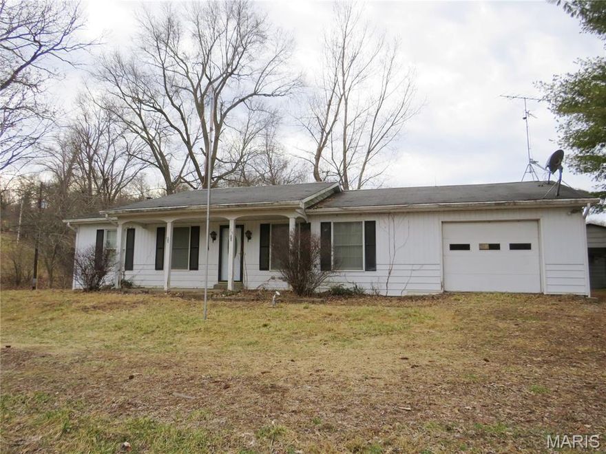 Escape to the peace of the countryside—just minutes from Jefferson City! Nestled in a beautifully shaded country setting, this charming 2-bedroom, 1-bath home offers the perfect blend of privacy and convenience. Enjoy the quiet surroundings while still being only a short drive to shopping, dining, schools, and all the amenities Jefferson City has to offer. Inside, you’ll find a comfortable and functional layout ready to make your own. The home features a full unfinished basement, providing abundant storage space and endless potential for a workshop, hobby area, or future expansion. Car enthusiasts and hobbyists will appreciate the oversized 1-car garage, offering extra room for tools and equipment, plus a separate carport for additional covered parking. A dual heating system adds year-round comfort and efficiency, giving you peace of mind through every season. If you’ve been searching for a serene setting with convenience close by, this country gem is ready to welcome you home!