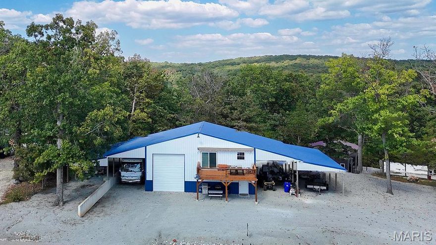A one-of-a-kind Lake View Barndominium that combines rustic charm, with modern smart-home technology. Featuring one bedroom, one full bath and an open concept design. This property offers both style and comfort. Enjoy the incredible lake views from your own home in this gated lake community just 45 mins south of St. Louis. This home includes a 40x45 attached drive through garage plus three extra garage bays, providing exceptional space for boats, ATV/s, RV parking and all your lake toys.  The thoughtful floor plan highlights natural finishes & modern design. Residents enjoy a resort- style amenities including two ramp, fishing ponds, sandy beach,  swimming pool, clubhouse and multiple parks. Whether your seeking a full- time residence or a the perfect space for weekend getaway, this home and shop space delivers versatility and design. The home residence space is on the upper level but main level is ready for your personal touch finishes for extra livable space but offers the first full bathroom set up already. Home is located on 3 lots with a nice backyard area too for privacy.  The seller is ready for their next adventures- don't miss this opportunity to own a truly special lake property. Bring your buyers and bring us an offer! The seller owns 3 additional lots across the street together-lake view, he is considering selling too with an a strong offer.
