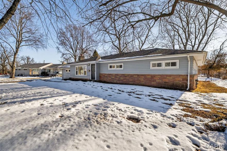 This spacious three-bedroom, 2 bathroom ranch home in Kenwood Terrace offers nearly 2,000 square feet of single-level living space on an expansive 0.36-acre lot. The interior features an open floor plan with a functional kitchen-dining combo, a breakfast room, and a living area centered around a wood-burning fireplace and built-in bookcases. Large windows throughout provide natural light, while the primary level houses all four bedrooms for a convenient layout. Practical amenities include an attached two-car garage, a separate detached garage for additional storage or workshop space, and a slab foundation. The oversized, level backyard offers ample room for outdoor activities. Located near local parks and within the Hazelwood West school boundaries, this well-proportioned residence provides significant living space and a versatile floor plan in a quiet, established community.