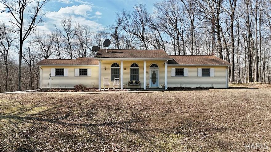 Welcome home to this charming 1990 ranch-style property offering comfort, efficiency, and room to breathe on 2.57 beautiful acres. With 3 bedrooms and 1 bath, this well-maintained home delivers simple, functional living in a peaceful setting just 10 minutes from town. Step inside to a spacious living room featuring a vaulted ceiling that enhances the open feel, along with a cozy electric fireplace framed by built-in shelving on both sides—perfect for displaying decor, books, or family keepsakes. Updated LVT flooring runs throughout the main living areas, providing durability and modern appeal. The eat-in kitchen offers abundant cabinetry plus open shelving ideal for showcasing your favorite dishes or decorative pieces. A 1-car attached garage adds everyday convenience. One of the standout features of this property is the impressive 32x50 shop. Plumbed for geothermal and already roughed in for a future bath, this versatile space includes an overhead door and drive-through sliding doors designed for RV or camper storage—so you can finally stop paying those monthly storage fees. Whether you need a workshop, hobby space, business area, or extra storage, this shop delivers flexibility. Outside, enjoy 2.57 acres dotted with beautiful mature trees and thoughtfully landscaped beds that are just beginning to show off their spring color. Tucked away on a private lane, you’ll love the quiet country feel while still being conveniently close to town amenities. This home checks all the boxes for comfortable country living…and it priced under appraisal!