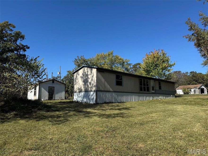 Country Living on 5.30 acres M/L with a Single wide (16 x 70) 2 Bedroom 2 Bath home with underpinning & tie downs and a back Deck and sidewalk. Has a one car 15 x 20 detached garage with opener,  14 x 16 storage shed, a 10 x 10 storage shed, Well House and another older garage/shop building. Has a lagoon and a drilled well. Intercounty electric is the provider, Green Forest School and Salem Fire district. This is on a dead end road so there is only one other home at the end of the road. Current River and Montauk isn't far from this property! 
Don't let this get away from you! Call for your appointment today to see this.