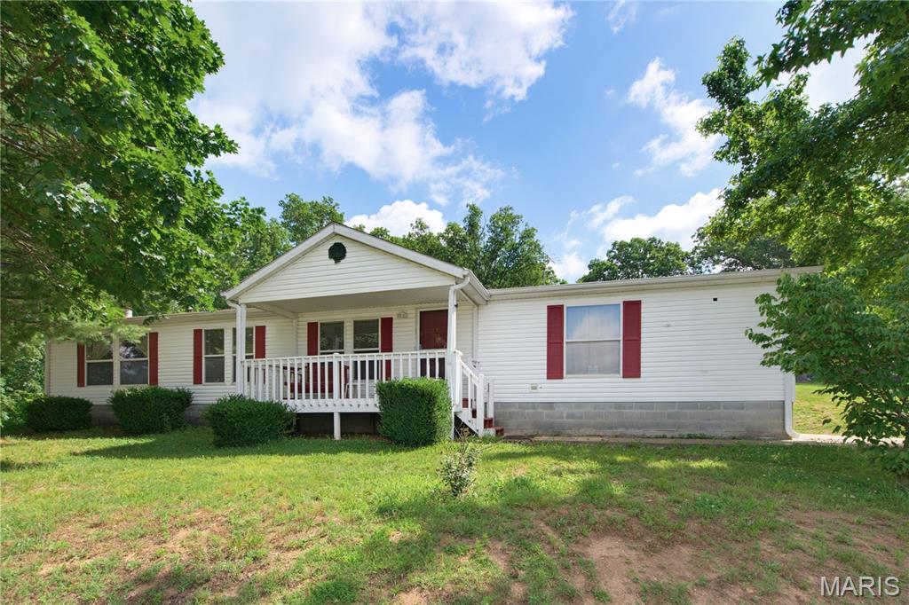 Ranch-style home featuring a porch