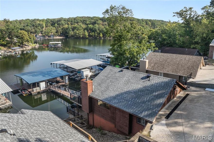 Lakefront Living with Gentle Lot & Deep Water in Sunrise Beach! Your search is over—this charming 3 bd / 3 bath ranch-style walkout home checks all the boxes for an ideal lake retreat or full-time residence. Perfectly positioned at MM25 in a quiet, no-wake cove w/deep water & a wide lake views, this home offers serenity & unbeatable lake access. The main level features an open floor plan w/beautiful hardwoods, cozy fireplace, Pella sliding doors, Trex decking, updated kitchen w/granite countertops, & modern finishes. Also on the main level: 2 bedrooms & 2 bathrooms. Lower level offers a 3rd bedroom & bath, plus a family room w/ laundry area. Step outside to a spacious lower deck, & from there, 3 easy steps to the dock walkway leading to private 1-well dock w/swim platform & infinity steps. 2nd well filled in & can be easily converted back. Additional highlights: Concrete parking pad for 4 vehicles, ready for a future detached garage, well-kept neighborhood, Minutes by boat or car to waterfront restaurants, & just a short drive to both Camdenton & Lake Ozark. Whether you're looking for a peaceful getaway or a home that keeps you close to lake fun, this one offers it all!