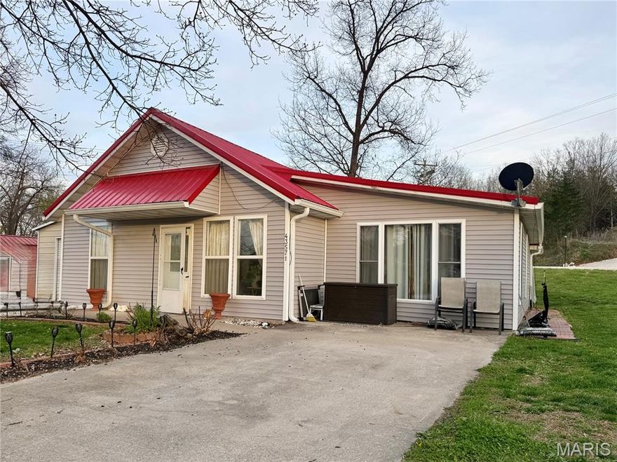 This main level living home is located just of Rt J only minutes to Mark Twain Lake. Boating, fishing, swimming all at your finger tips! There is a detached garage and a "she shed" (both have electricity). The current owners widened the driveway so there is easy access for parking a camper or boat. The drive connects Blue Lagoon and Willow so drive right through! The roof over the back patio/porch has been extended and "curtain like" tarping around it during the winter helps keep the space usable all year long. In the summer, take it down for an open air area to entertain friends and family! Inside you will find a spacious living room, and dining room. In the kitchen,  new cabinets, countertops and backsplash. New lighting, ceiling fans and flooring! Lots of updates.  Right now the home is set up with two bedrooms but there is another room that can easily be a third bedroom. You just need a wardrobe or closet installed. It's currently being used as storage and laundry.  The home has no steps to enter so easy access for everyone. The HVAC is 3 years old, metal roof is about 7 years. If you are looking for a summer home near the lake or a full time residence, you need to take the time to check this one out.