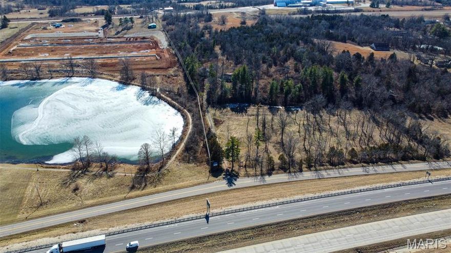 This property has 12.99 acres m/l acres with 497 feet of I-44 frontage located adjacent to Blue Lake and the Rolla City Limits. This location offers development potential and with it's I-44 exposure and nearby recent development would make a great location for any business. The property is nestled in a beautiful, wooded setting with lake, valley and sunset views, mature walnut and oak trees, and a creek. The interstate exposure and location close to town provide lots of commercial possibilities with the option of having living quarters on site. Location: Hwy/Interstate Front