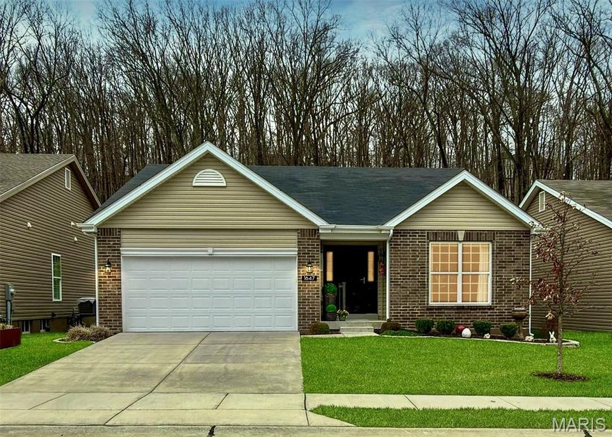 Welcome to one of the most desirable streets in Windswept Farms—offering a rare setting with no homes behind, wooded privacy, and tree-lined views across the street, creating a truly peaceful and private environment. This meticulously maintained, 3-year-young home features sought-after 3/4” White Oak hardwood flooring throughout, vaulted ceilings, and a warm gas fireplace, creating an open and inviting main living space. Designed to maximize natural light, the home showcases 6-foot windows throughout, bringing in abundant sunlight and highlighting the beauty of the surrounding outdoor views. The kitchen is well-appointed with quartz countertops, custom tile backsplash, 42” soft-close cabinetry with crown molding, and stainless steel appliances, blending style and functionality. Enjoy reverse osmosis filtered water and softened water from the whole-home water softener. The dining area is enhanced with optional bay windows, adding architectural interest and additional space while creating a bright and inviting setting for everyday living and entertaining. A true standout feature of this home is the custom-designed four seasons room addition—a thoughtfully upgraded space that elevates the entire floorplan. Unlike the standard layout, this enhanced living area is fully heated and cooled and showcases floor-to-ceiling custom bronze-tinted windows, the French doors, and hardwood flooring, creating a seamless extension to the home. The home is further enhanced with custom linen draperies throughout, along with extensive lighting selections that add a refined, designer feel. The bathrooms offer marble flooring, updated mirrors, lighting, and fixtures for a clean and elevated look. Thoughtful improvements continue outside with professional landscaping, a front and rear irrigation system, a painted foundation, and a new storm door. The garage has been upgraded with added insulation, finished walls, and fresh paint. Inside, you’ll also find a spacious walk-in pantry and a large laundry room with navy ceiling-height cabinetry and a custom cubby storage system.
The lower level offers excellent future potential with a bathroom rough-in and an egress window allowing for a potential 4th bedroom, along with a layout ideally suited for an expansive rec room finish.
Located within Eureka city limits, this home benefits from public water and sewer, city-maintained streets, and fiber internet, while enjoying lower Jefferson County taxes—all within Rockwood School District. The remaining portion of the 10-year builder structural warranty is transferable to the new owner.