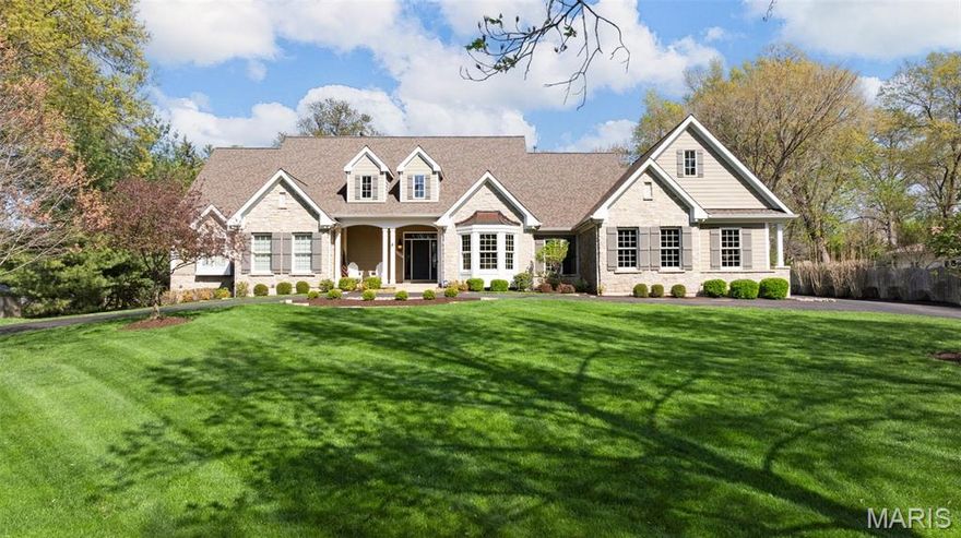 This exceptional estate masterfully blends timeless elegance with modern comforts on a pristine, professionally landscaped one-acre lot. Mature trees and lush gardens frame the circle drive, while a side-entry three-car garage with carriage-style doors offers both charm and convenience.  Inside, a dramatic two-story foyer sets the tone, leading to formal dining and a soaring great room with floor-to-ceiling stone fireplace, custom built-ins, and a breathtaking wall of windows that flood the home with natural light.  
The newly remodeled chef’s kitchen is a true centerpiece, featuring quartz surfaces, bespoke cabinetry, double ovens, a five-burner gas cooktop, and a butler’s wet bar—ideal for hosting in style. Gather in the hearth room with its inviting fireplace or in the breakfast room, where serene backyard views create a perfect start to the day.  The main-level primary suite is a private sanctuary, complete with a sitting area, a spa-inspired bath, and a custom-designed walk-in closet. Two additional bedrooms with a Jack & Jill bath share this level, along with a spacious home office, a designer laundry suite, and thoughtful built-ins including mudroom cubbies with direct garage access.  Upstairs, two more bedrooms and a full bath provide versatility for family or guests, with a balcony overlooking the great room. The finished lower level is an entertainer’s dream: a full wet bar with icemaker and beverage center, a cozy fireplace, billiards and recreation areas, and a full bath—all with convenient walk-up access.  Additional luxuries include extensive millwork and casings throughout, three-zone high-efficiency HVAC, whole-house audio, central vacuum, security system, and future-ready features such as basement laundry rough-in. This residence is more than a home—it’s a lifestyle of sophistication, privacy, and enduring quality. (Kitchen and Primary Suite have been remodeled)