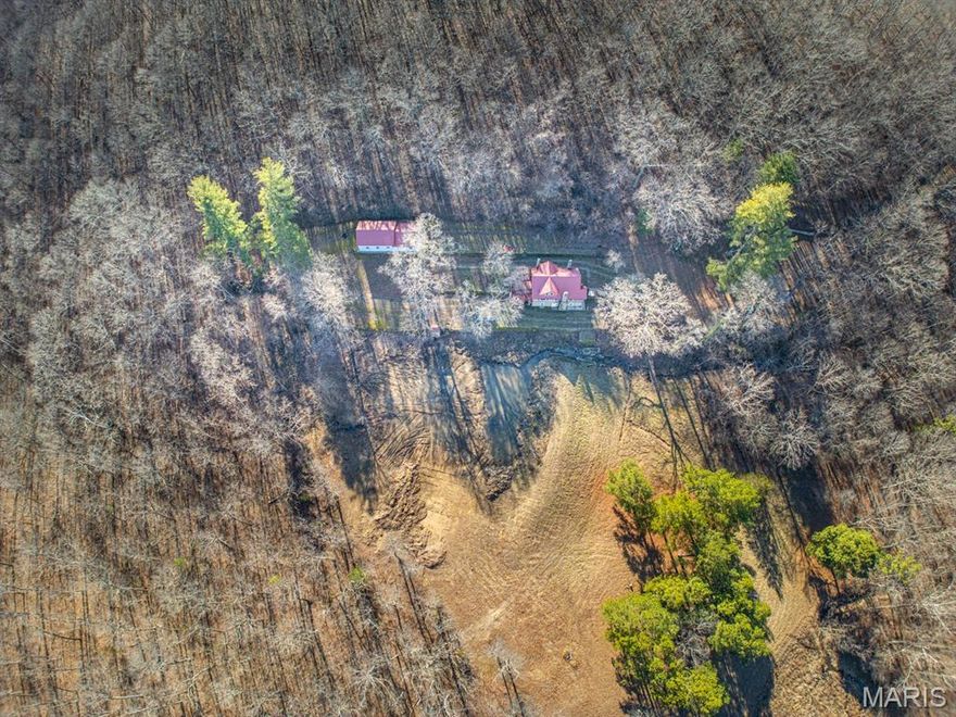 Whisper Spring runs into the pond as the star of the view but wait, this completely renovated Stone home also overlooks beautiful mature woods carried on wind to a song you can hear. Surrounded and secluded finds wildlife you're constant companion and entertainment. With 64 Beautiful Ozarkian Acreage of woods and wonder welcoming this truly impressive setting.  Winding down this private lane from the black top reminds me of the beginning of a great fable.  Love seclusion? This is it, far from the traffic and people, your shoulders immediately relax.  Every window overlooks nature, wood floors revived by Owner shine, remodeled kitchen with stone countertops, beautiful cabinetry & Accessories, Range, Dishwasher and refrigerator match the feel of the room making any Cook a Chef. French Doors lead to a very viewfest deck re-stained & ready for your entertainment or a small meal on the BBQ.  The Rock floor to ceiling original Fireplace is a stunning feature with choice rock/crystal peeking sparkle through your  delights & senses.  The bedrooms upstairs are spacious and cozy with a full bath.  This stunning property host an older shop/garage, beautiful rock retaining walls and decor' you will enjoy for many years to come.  Comfort and clean, this home has all the Central Heat & Air and modern built-ins to make your life as easy as possible.  Retaining the past and adding the conveniences of today is a very popular decor',  Call soon, this one already has action. 
This is a duplicate listing to residential listing number 25076671.