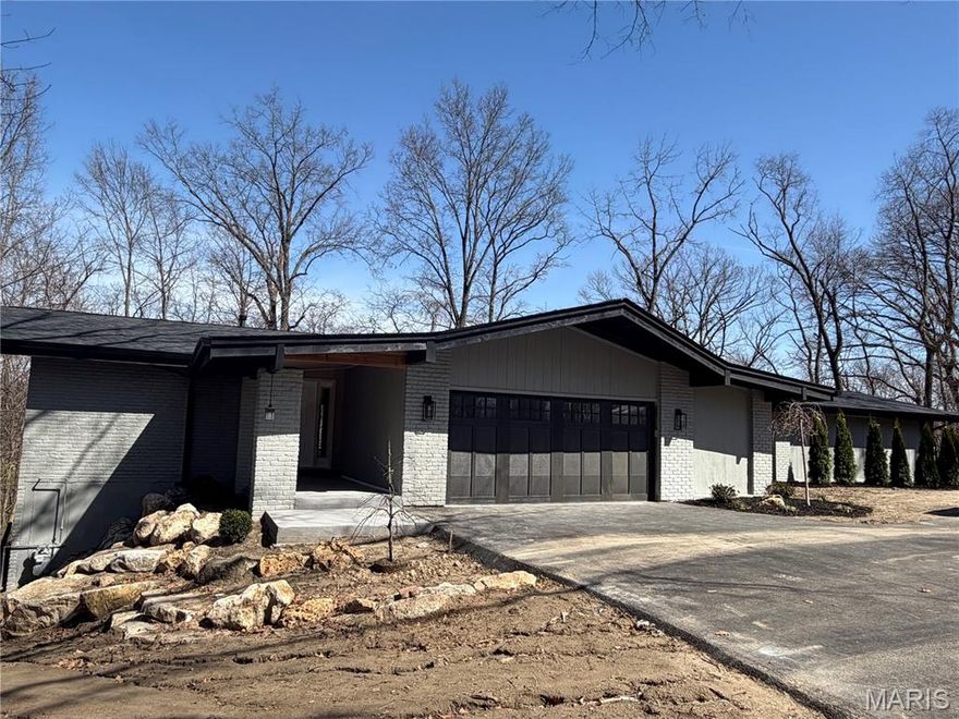 Exceptional hilltop retreat in the highly sought-after Green Trails neighborhood. This completely gut-rehabbed contemporary walk-out ranch offers 5 bedrooms and 3.5 baths on a spectacular 1.2-acre lot surrounded by wooded common ground, providing rare privacy while being ideally located in the heart of the community just minutes from top-rated schools, dining, and shopping.
Thoughtfully redesigned with high-end finishes throughout, the home features pre-finished white oak flooring, custom cabinetry, quartz countertops, and designer lighting. The stunning kitchen is equipped with GE Cafe Appliances along with wine and beverage refrigerators, creating an ideal space for both everyday living and entertaining.
The luxurious primary suite serves as a private retreat with a vaulted shiplap ceiling, two walk-in closets, and direct access to a private patio. The spa-inspired primary bath features a double vanity and an oversized walk-in shower with seating.
The walk-out lower level offers a dramatic sunken family room with a stone-faced fireplace and wet bar—perfect for gatherings, relaxing evenings, or hosting guests.
Extensive upgrades include Pella windows and doors, a new architectural shingle roof, composite deck, new asphalt driveway, professional landscaping, zoned HVAC, a 75-gallon water heater, and a Generac generator. Walk-in closets in four of the five bedrooms provide excellent storage and functionality.
A rare opportunity to enjoy modern luxury, exceptional privacy, and a prime location in the heart of the sought-after Green Trails community.