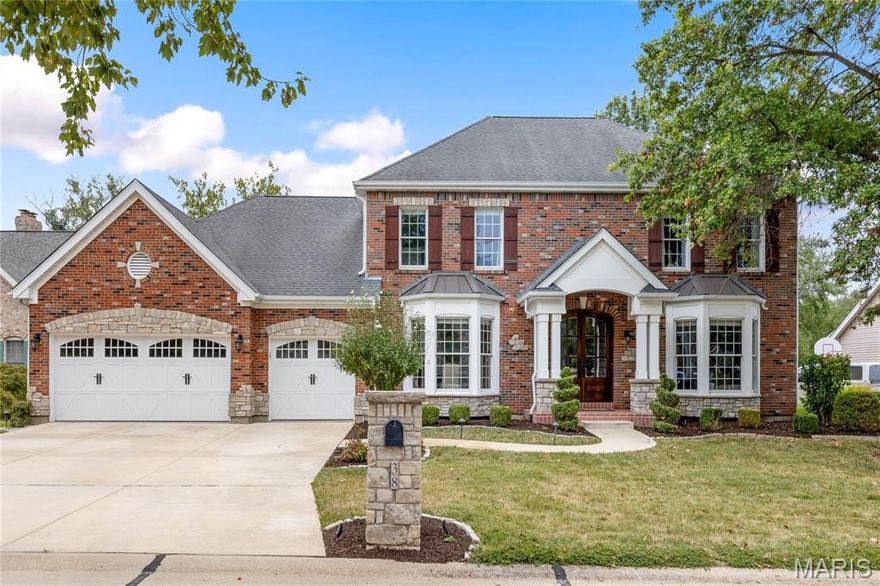 Hardwood flooring, hand hewn beams & stacked stone accent walls provide this updated brick & stone 2 Sty a sense of rustic elegance. Impressive 2-sty foyer leads to well-appointed study, formal dining room with wide bay window & spectacular great room with stone fireplace flanked by bookcases & expansive bank of windows. Vaulted kitchen with timber beam trusses, granite countertops, bisque cabinetry, 6' center island & butler's pantry adjoins light-filled breakfast room that opens to private deck that overlooks pool & wooded ground. Front & rear staircases access coffered primary bedroom suite with luxury bath with freestanding tub plus 3 additional bedrooms, 1 with ensuite bath & 2 with Jack n’ Jill bath. Lower Level entertainment space includes recreation room with floor-to-ceiling fireplace & wet bar, game room, office, workout room & full bath. Atrium doors open to outdoor living area with deck, pool with waterfall, covered patio with granite bar & fire pit.