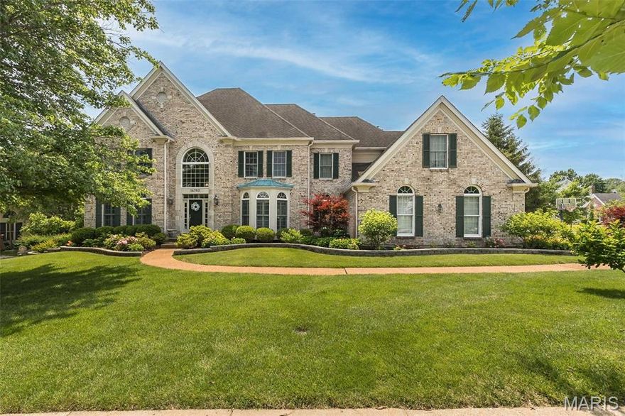 Classic-styled brick 2-Sty in premier neighborhood. This former Jones display features an open floor plan with oak hardwoods, detailed trim work, Palladian windows & plantation shutters. Impressive 2-sty entry foyer leads to private study, formal dining room with wide bay window & library-paneled great room with box beam ceiling, wet bar & marble fireplace flanked by built-in bookcases. Chef’s kitchen with 42” white cabinetry, KitchenAid  appliances, 4’ center island & butler’s pantry adjoins light-filled breakfast room with convenient planning center & vaulted hearth room highlighted by brick fireplace. T-staircase accesses coffered primary bedroom suite with luxury bath with jetted tub & sitting room plus 3 additional bedrooms, 1 with ensuite bath & 2 with Jack n’ Jill bath. Walk-out Lower Level includes family room with entertainment center, wet bar, fireplace & office area plus 5th bedroom & full bath. Situated on a .5-acre lot with wrap around deck, covered patio & 3-car garage.