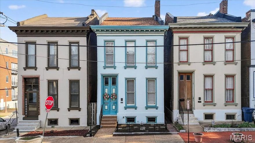Est. 1879 — Meticulously renovated (2017) Painted Lady in historic Lafayette Square blending modern amenities with original character. Dramatic 10’ storm and custom entry doors open to a foyer with refinished wide-plank hardwoods and soaring ceilings. The sun-filled living room features oversized windows, an original marble fireplace, and custom crown molding, while the dining room showcases exposed brick accent walls. The rear kitchen offers granite countertops, 42” mocha cabinets with under-cabinet lighting, stainless appliances, and access to a spacious deck overlooking a beautiful landscaped yard, plus a main-level half bath. Upstairs, the original staircase leads to a front primary bedroom with triple windows and southern exposure, two additional bedrooms, and an updated full bath with ceramic tile. The finished third-floor recreation room/loft provides flexible space for a home office, yoga retreat, or dressing room.  New HVAC 2023, new roof 2019.  Seller offering a Home Warranty.  A rare opportunity to own a single-family Painted Lady in one of St. Louis’ premier historic districts.