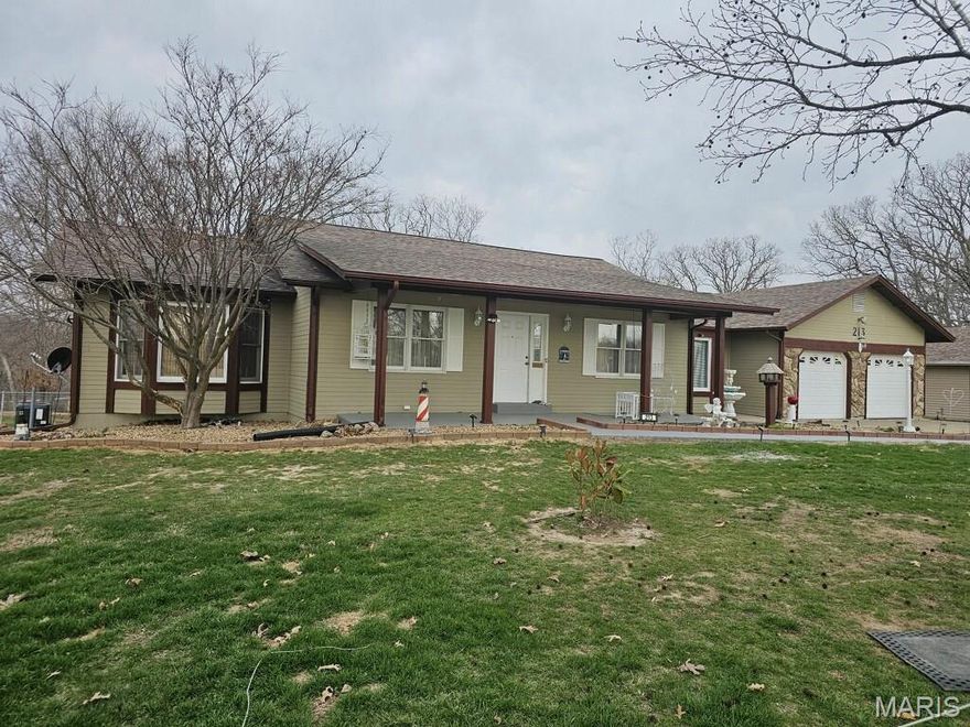 If you’re seeking privacy, space, and a spectacular setting, you’ll love 213 Lincoln Ln in the quiet town of Winfield, Missouri. This beautiful three-bedroom, two-bathroom home sits on an expansive 3-acre lakefront lot, offering rare access to a large neighborhood lake where you can enjoy peaceful views, fishing, or simply unwinding at the water’s edge. The exterior features a spacious two-car garage, an additional detached garage ideal for hobbies or storage, and a generous fenced backyard. Whether you’re sipping coffee by the shoreline or hosting friends outdoors, this property delivers a retreat-like experience. Enjoy your private above ground pool during the summer months just off your large deck that has gorgeous view of the lake! 

Step inside to a warm and welcoming family room with lofted ceilings, a striking wood-burning fireplace, and a walkout to the impressive three-seasons room. This sun-filled space is surrounded by an expansive deck, creating a perfect flow for weekend gatherings or quiet evenings overlooking your property. The large kitchen is sure to please any home chef and boasts custom cabinetry, granite countertops, a stylish backsplash, and a bright breakfast room with a lake view. The main floor also offers two comfortable guest bedrooms and a lovely primary suite featuring a dual-vanity bathroom and a beautiful walk-in shower. A partially finished walkout basement adds even more versatility, providing a great entertaining area with ample room for future expansion.