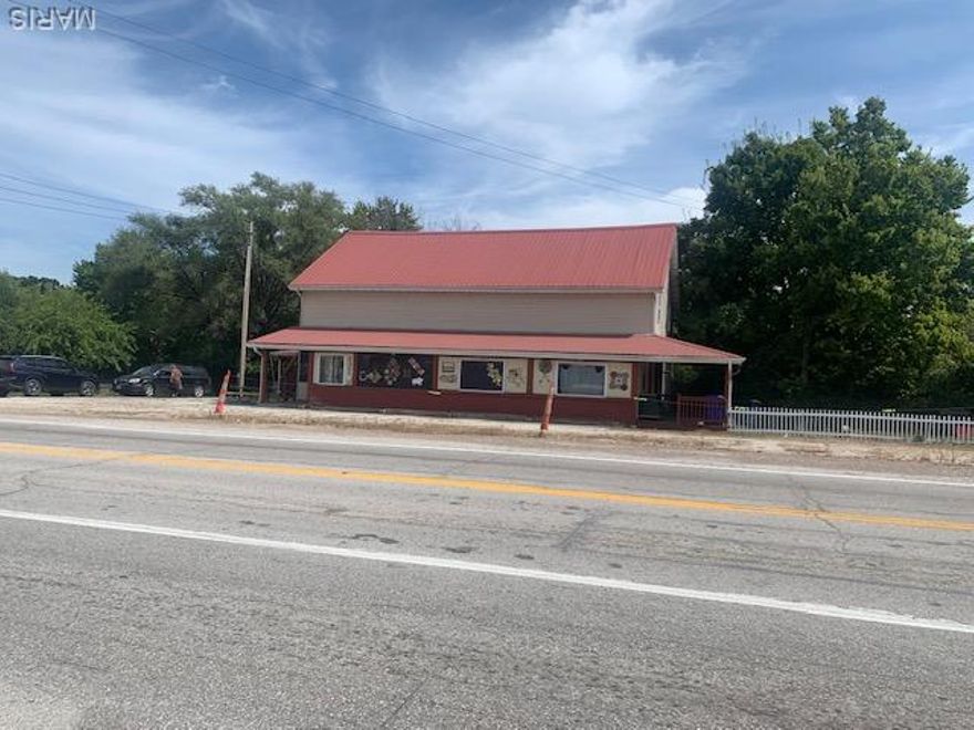 This commercial/residential property would allow you to operate a business and live upstairs.  Super convenient.  OR  provide  the manager free rent space.   Main level space includes several large rooms perfect for a resale shop or convenience store.  A kitchen space with stainless sink and drain area.  Public rest room.  Upper level living space has full kitchen bathroom  bedrooms and living area.  PLUS outside entrance.  Clean up the space add fresh paint and organize to fit your needs.  Building is very solid, steel roof will last for years.  Public water and sewer.  Located on a high traffic intersection.