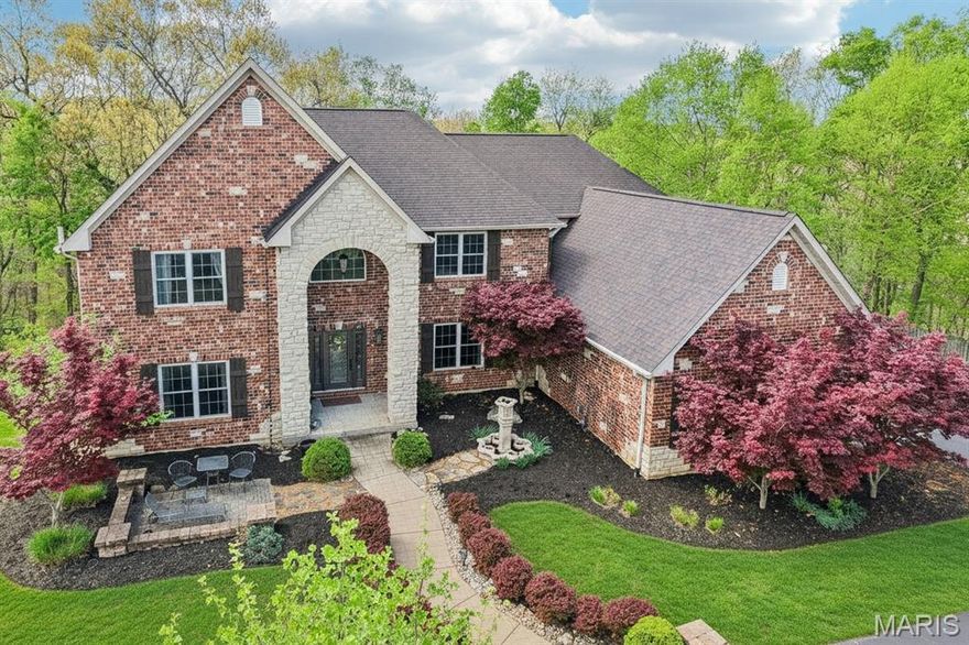 Tucked within an exclusive gated community in desirable St. Louis County and located in the award-winning Rockwood School District, this stunning brick and stone estate offers luxury, privacy, and exceptional indoor-outdoor living on 3 acres. A circle driveway and side-entry 3-car garage create an impressive arrival, while the private, fenced backyard backing to mature forest provides a peaceful escape. Entertain with ease in the thoughtfully designed outdoor spaces featuring a biergarten, pergola, newer covered deck, stamped patio, and included hot tub.
Inside, a dramatic 2-story entry opens to a breathtaking great room with gas fireplace and a wall of windows showcasing serene views. The grand staircase with wrought iron spindles makes a statement, while the formal dining room features cased, arched openings and a coffered ceiling with crown molding. A private den offers a quiet workspace, and the expansive kitchen boasts a center island, granite countertops, double ovens, and glass display cabinetry. The main floor primary suite is a true retreat with a bay window, coffered ceiling, and a spa-inspired bath designed for relaxation, plus convenient main floor laundry with sink.
Upstairs, bedrooms 2 & 3 share a bath with double vanities, offering both comfort and functionality, while bedroom 4 enjoys easy access to a hall bath—ideal for guests or family. A spacious upper-level family room with French doors and a Juliet balcony overlooks the great room below, creating an open, connected feel perfect for everyday living or entertaining. The finished walk-out lower level expands your living space with a rec rm featuring a bar, dedicated theater room for movie nights, a private 5th bedroom, and full bath—perfect for guests, multigenerational living, or a private retreat. Thoughtful updates include new paint (2020), garage doors/openers (2021), humidifier (2023), deck (2023), and architectural roof with gutter guards (2024), 220 Outlet to exterior, Double Oven and some lighting.
******The main route off 44/141 will be closed until Mid-May (Beautiful Road Improvements on the way!) For Now...you'll need to take the back roads in via Hwy 30 until this project is completed in MAY 2026.*****