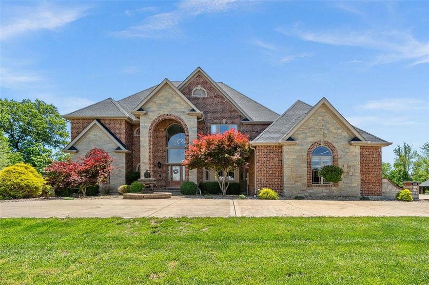 Amazing custom built home on 5.97 acres with professionally landscaped grounds that look like a resort. Pull around to the circle drive to this private oasis that has been impeccably maintained. Brick and stone facad with 2-story entry leading you into great room with wall of windows, gas fireplace, & built-in bookshelves. The gourmet kitchen features a huge center island, high-end appliances, granite and opens to a spacious breakfast room & hearth room. The kitchen has amazing views overlooking the beautiful pool and 2 acre stocked lake with stone column gazebo and dock. Built in pool with diving board and plenty of space to entertain including the covered patio area and pool deck area.  Main floor master suite includes a luxury bath and private access to the pool area. Extensive mill work and moldings throughout add to the warm and gracious feel, yet enhance the features today's buyers require. Formal dining room and office located on main level. Convenience is key with a laundry room on the main and upper levels.  All bedrooms have bathrooms. The 4 car over sized garage has a newly installed amazing garage system! Partially finished LL boasts custom gym with glass doors. Newer roof and newer AC Units