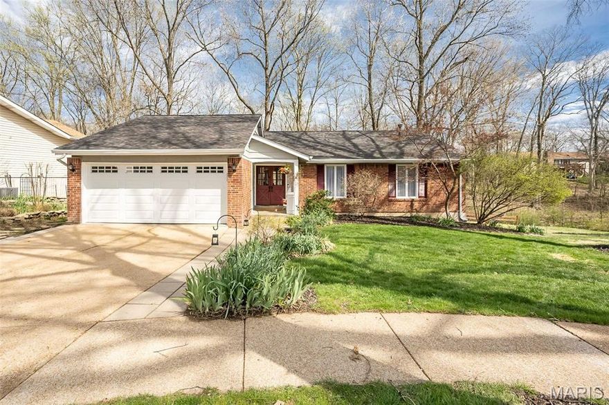Did you dream of living in a tree house as a kid? This is your chance. Nestled on a wooded cul-de-sac in the heart of West County, this charming 3-bedroom, 2-bath home delivers that storybook feeling with all the modern amenities you need — and Parkway South Schools to boot.

The updated kitchen provides slate counters, a tile backsplash, a custom built-in bar, and a center island on wheels — plus sliding doors leading to the freshly updated deck. The family room has a dramatic corner window bank flooding the space with natural light, vaulted ceilings, and a wood-burning fireplace with brick surround. The generous primary suite offers room for all your furniture, a cozy reading nook, and an updated ensuite with a walk-in shower and single vanity. Two additional bedrooms and an updated full bath complete the main level.

The walk-out lower level provides additional living space with a finished rec room and office area. Then, step outside to a backyard oasis meticulously designed for relaxation with a brick patio for gatherings, plus an outdoor shower. All of this, just minutes from top schools, parks, shopping, and highway access. Don't miss this Country Lane Woods gem!
