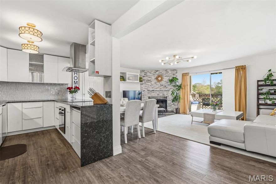 MUST SEE!! 2 bed/2 bath and beautifully maintained condo with a large, open and stylish living space.  This apartment-style home features a fully remodeled kitchen with granite countertops, white cabinetry, and updated fixtures, along with updated bathrooms in a clean, modern style. Enjoy the convenience of in-unit laundry, making everyday living easy and efficient. Step out onto your private porch overlooking a peaceful green space-ideal for recreation and dog walking. Additional features include a covered parking spot and well-kept surroundings that add to the home's overall appeal. WELCOME HOME!