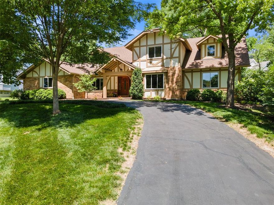 From the moment you pull up to this classic brick and Tudor-style home, you'll know it's special—it’s the one that stands out, perfectly perched on its large circle drive. Step inside and you’re greeted with the kind of thoughtful updates and comfortable spaces that make a house feel like home. The main floor primary suite is a peaceful retreat, complete with a beautifully updated luxury bath—think heated floors, tiled shower, and a custom walk-in closet. At the heart of the home is the great room with a dramatic cathedral ceiling, crowning the wall of windows flooding the space with natural light. Whether you’re hosting friends or enjoying a quiet night in near the cozy fireplace, this space was made for making memories. The kitchen has all the right updates—warm maple cabinets, granite countertops, stainless appliances. The breakfast room is sunny and bright, while the dining room offers a casually elegant mood. A spacious main floor laundry/mudroom (with serious storage and full-size appliances) keeps everyday life running smoothly. Everything you need for daily living is on the main floor—comfort and convenience at its finest. Upstairs you’ll find three charming, generously sized bedrooms and a surprisingly roomy full bath--perfect for guests or a growing crew. Out back, the secluded yard and patio offer private space to play, entertain and relax. It’s that hard-to-find mix of timeless style, quality updates, and easy everyday living—all wrapped up in one beautiful home.