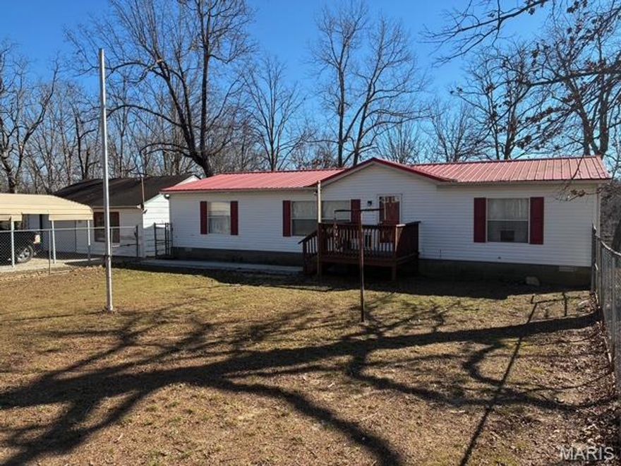 3 bedroom, 2 bathroom mobile home with a metal roof and a block foundation on a concrete pad. Sitting on 4.6 acres m/l it has a shared pond and joins government land. Property is on both sides of the county road. Offers a detached garage/shop with water and electric. Fenced in front yard.