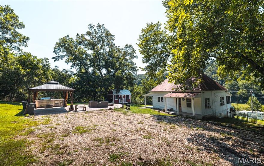 Discover 215 pristine acres of Ozark beauty featuring mature forest untouched for over 50 years, lush river bottoms currently in hay production, and three scenic ponds—including one spring-fed. An extensive UTV trail system winds throughout the property, connecting pine and hardwood forests to approximately 40 acres of open fields, perfect for food plots. With ponds scattered across the landscape, wildlife never needs to leave—making this a premier destination for whitetail deer and turkey hunting. The property borders Missouri Department of Conservation land along its entire west side and sits directly across a county road from Mark Twain National Forest, providing endless opportunities for recreation and added privacy. a charming 2 bedroom Farmhouse with an outdoor kitchen as well las screened and covered porches overlooking the bottom fields an ideal spot to relax and enjoy abundant wildlife views. and an kitchen Best of all, this property is just ½ mile from Montauk State Park, Missouri’s premier trout park, and only a short 150-yard walk through the National Forest to the Current River for your own private trout fishing. Conveniently located just 15 miles from Salem (Gateway to the Ozark National Scenic Riverways), 40 miles from Eminence (the trail riding capital of the Ozarks), and 15 miles from Flat nasty Off-Road Park, this rare offering combines natural beauty, recreation, and location into one exceptional property.