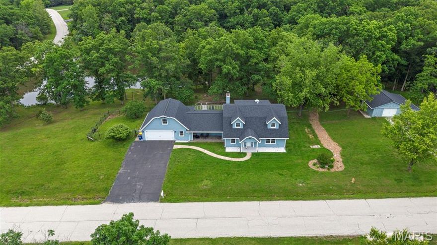 Does living the life fishing, swimming and relaxing around your private pond, on a home on acreage sound good to you? Then check out this HUGE 1.5 story home with a private, shared pond w/dock, beautifully wooded lot w/amazing views & attached garage & detached garage, all on 2.85 acres w/public sewer & water! Over 3400 sq ft w/5 bdrms & 2full/2half baths! HUGE rooms throughout, plus an awesome sunroom! Great Rm has wood burning stove & walkout to oversized stamped concrete patio, perfect for family and entertaining! Beautifully updated kitchen w/island w/stainless top, stainless farm sink, pot filler at stove, walk in pantry, more! Huge dining area to host all the holidays! Main floor primary suite offers luxury bath w/large walk in shower, lg corner jetted tub, double sinks, tons of cabinets and a private, built in sauna! Additional main floor bdrm (could be used as office). Upper level offers 2 bdrms/full bath on right side of home & huge 5th bdrm/office on left side over garage! Finished garage w/storm shelter. Detached garage also is extra deep with finished office area & half bath. Newer roof, fresh paint & trim, 2 newer water heaters! Fenced yard area set up to keep chickens in, if desired! Convenient access to highway and shopping! No sign in yard.