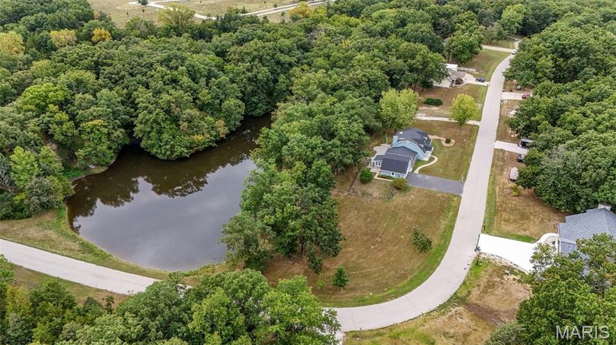 Does living the life fishing, swimming and relaxing around your private pond, on a home on acreage sound good to you? Then check out this HUGE 1.5 story home with a private, shared pond w/dock, beautifully wooded lot w/amazing views & attached garage & detached garage, all on 2.85 acres w/public sewer & water! Over 3400 sq ft w/5 bdrms & 2full/2half baths! HUGE rooms throughout, plus an awesome sunroom! Great Rm has wood burning stove & walkout to oversized stamped concrete patio, perfect for family and entertaining! Beautifully updated kitchen w/island w/stainless top, stainless farm sink, pot filler at stove, walk in pantry, more! Huge dining area to host all the holidays! Main floor primary suite offers luxury bath w/large walk in shower, lg corner jetted tub, double sinks, tons of cabinets and a private, built in sauna! Additional main floor bdrm (could be used as office). Upper level offers 2 bdrms/full bath on right side of home & huge 5th bdrm/office on left side over garage! Finished garage w/storm shelter. Detached garage also is extra deep with finished office area & half bath. Newer roof, fresh paint & trim, 2 newer water heaters! Fenced yard area set up to keep chickens in, if desired! Convenient access to highway and shopping! No sign in yard.