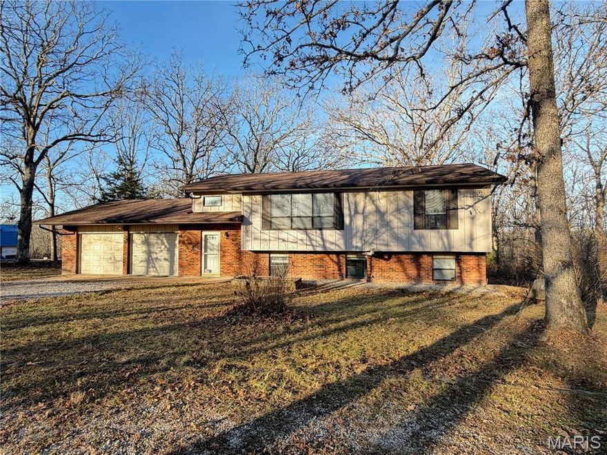 Beautiful 4-Bedroom, 2.5-Bath Split-Level on Nearly 3 Acres

This 4-bedroom, 2.5-bath split-level home sits on a park-like setting of nearly 3 acres, offering space, privacy, and peaceful country living. The main level features an open floor plan with a generously sized living room, dining area, and kitchen with abundant cabinet and counter space. Just off the dining room, a large deck provides the perfect spot for grilling, entertaining, or relaxing while enjoying the scenic views.

The main floor includes two bedrooms, including the primary bedroom with its own bathroom featuring a shower and toilet. The lower level offers a comfortable family room with a fireplace, plus a bonus room with built-in bookcases—ideal for a library, office, or media space. A laundry room is conveniently located off the bonus room and also houses the furnace and water heater. Two additional bedrooms and a full bathroom complete the lower level.
A walkout leads to a back porch with a concrete patio that opens to the spacious backyard, offering plenty of room for gardening, a play area, or simply enjoying the natural surroundings. With almost 3 acres of space, a quiet retreat, and less than 3 miles from town, this property delivers the best of country living.