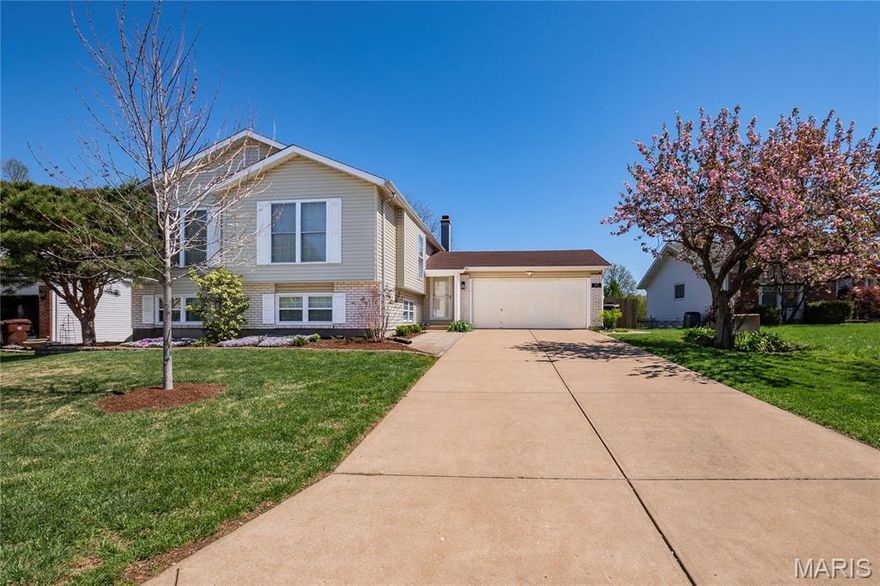 Welcome home to this beautifully maintained split-level gem nestled in sought-after St. Charles County and located within the highly desirable Francis Howell Central School District! Boasting 4 bedrooms, 2 full baths, and an open, airy floor plan, this home effortlessly blends comfort, style, and functionality.
Step into the inviting living room featuring stunning light laminate wood flooring and soaring vaulted ceilings that continue seamlessly into the kitchen—creating a bright and expansive main living space. The kitchen is equipped with stainless steel appliances (all included!) and is perfectly positioned to overlook the breathtaking wall of windows, flooding the home with natural light and offering picturesque views of the backyard.Just off the kitchen, step out onto the oversized deck—ideal for entertaining or relaxing—overlooking a massive, fully fenced yard that provides both privacy and plenty of room to play, garden, or unwind.The spacious primary suite is a true retreat, complete with vaulted ceilings, an entire wall of his-and-hers closets, and direct access to the beautifully updated Jack-and-Jill bath featuring a skylight for added natural brightness. Two additional generously sized bedrooms with ample closet space complete the upper level.Downstairs, the finished lower level is an entertainer’s dream! Enjoy a large family room with walk-out access to a patio, a cozy wood-burning fireplace with classic brick surround, a full bath, a fourth bedroom, and additional flex space perfect for a rec room, office, or home gym.An oversized attached 2-car garage and expansive driveway provide abundant parking and storage options.With space, updates, and location all wrapped into one incredible opportunity—this home is priced to sell and won’t last long!