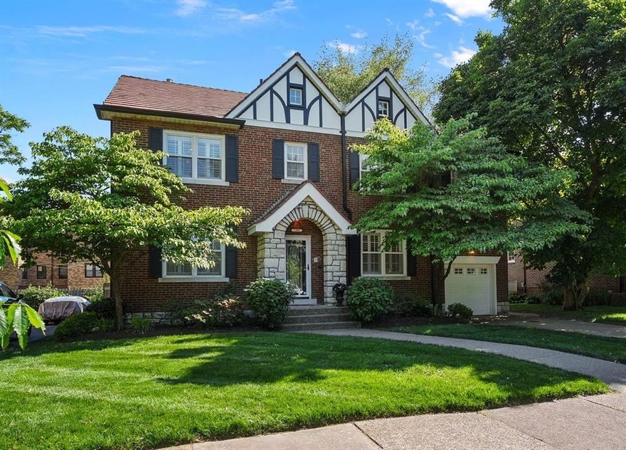 Nestled in the prestigious University Hills neighborhood, this elegant 2 1/2-story residence offers over 3,600 square feet of total living area. With 5 generously sized bedrooms and 3.5 well-appointed baths, this home seamlessly blends historic charm and thoughtful renovations. The beautifully updated kitchen is the heart of the home, complete with custom cabinetry, stainless steel appliances and center island serving as a place to gather. Complementing this are a separate dining room and inviting living room centered around a cozy fireplace and built-in cabinets. Connecting the living space to the 1-car garage is a laundry/mudroom addition for everyday convenience. The primary suite impresses with a custom walk-in closet and a remodeled spa-like bath with heated flooring. A partially finished lower level offers versatile space for recreation, storage and work. Outside, a charming patio with a pergola creates an idyllic setting for entertaining or quiet nights around the fire. Set amid mature tree-lined streets just moments from parks, shopping and dining, this residence embodies refined living in a private setting while still being close to it all. Please ask the listing agent or see the attached addendum for an extensive list of updates.