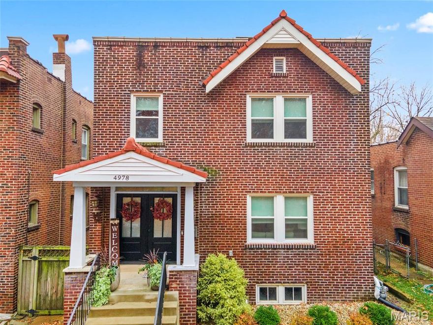 This spacious brick beauty offers amazing STL living. Generous rooms, abundant natural light, & a flowing floor plan make it ideal for both entertaining and everyday comfort. Newer amenities include roof, upper & lower deck, fencing, windows throughout, stately front door, & new flooring in all 3 baths. Convenient second floor laundry, 2nd story deck off back bedroom, main floor bed with full bath, 2 fireplaces, stained glass windows, tons of closet space, whole home natural gas generator, light filled basement with 2 sump pumps (battery backup), exterior gas line for future grill. There are 2 primary bedrooms, 1 on the main floor & the upper primary suite is huge offering the perfect place to relax.  Walk to Tower Grove Park, farmer's market, multiple coffee shops & supermarket! All this on a quiet street.  Start loving where you live!!