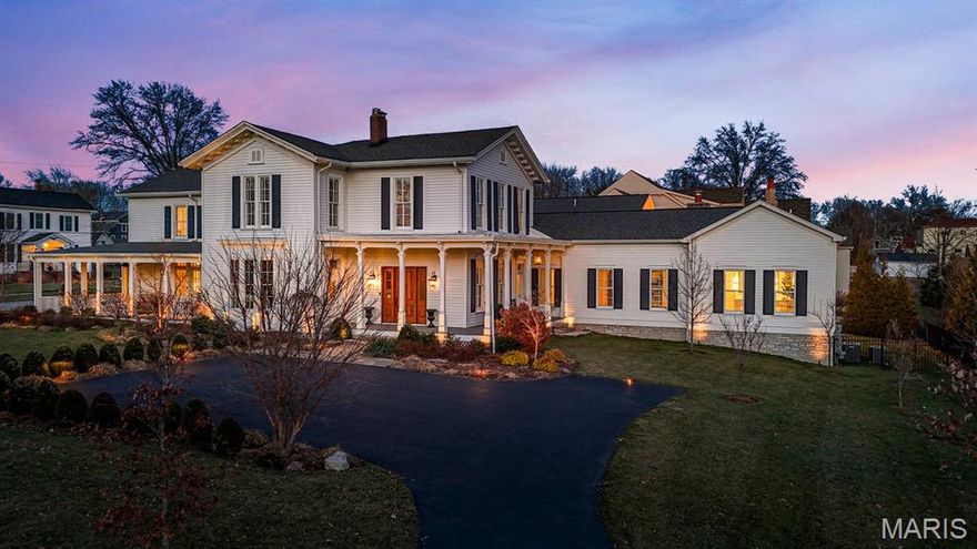 Presenting the Spencer Smith House, a designated Kirkwood Historical Landmark blending 19th-century Italianate architecture with thoughtfully integrated modern living.  Built circa 1853 and expanded in 2018, this distinguished two-story residence features cross gables, bracketed overhanging eaves, and a welcoming veranda. The home offers approximately 6,900 square feet of finished living space that preserves historic character while supporting contemporary living.  Architectural details include soaring 12-foot ceilings, a freestanding spiral staircase, curved walls, original niches, and a dining room bay window. Reproduced period millwork and rift- and quarter-sawn white oak flooring anchor the main level, while comprehensive updates to HVAC, plumbing, electrical, and structural systems modernize the home behind the walls.
The reconfigured floor plan creates an open sequence between the foyer, living areas, and kitchen through expansive cased openings that maintain architectural continuity.  Upstairs, four bedrooms, remodeled bathrooms, and an added laundry provide comfort and flexibility.
A thoughtfully designed addition integrates with the original structure while remaining architecturally distinct. Highlights include a main-floor primary suite, 3.5-bay attached garage, second-floor recreation room with half-kitchen, expansive outdoor deck with hot tub, gas fire pit, grill and wet bar, and a wrap-around porch overlooking the grounds.  Entire Smart Home Technology. Located within walking distance of downtown Kirkwood’s shops and restaurants, the Spencer Smith House offers the opportunity to own a carefully restored historic residence in one of the area’s most established communities.