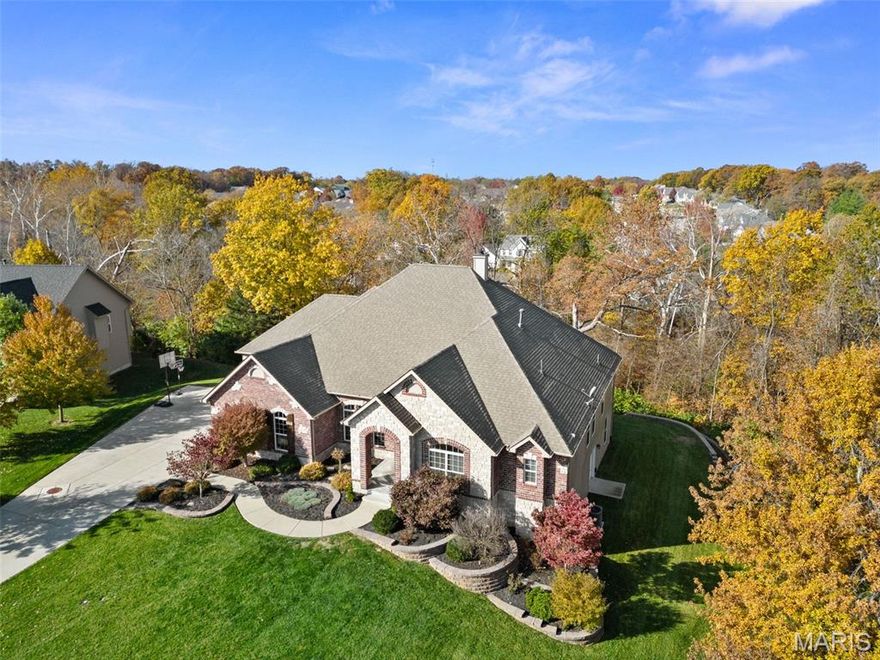 Tucked within an exclusive enclave of custom estates, this original-owner home offers a rare blend of sophistication, comfort, and nature—on 2.32 private wooded acres in the heart of Lake St. Louis. Minutes from top-rated Wentzville Schools, shopping, dining, and recreation, it’s both a sanctuary and a smart investment. Featuring 7 bedrooms (one a private office, another a fitness suite), 4 full & 2 half baths, including 3 luxurious en-suites—ideal for guests or multi-generational living. Gleaming hardwood floors, plush carpeting, and fresh paint create a move-in-ready feel. The great room boasts 14' ceilings & atrium windows, opening to a gourmet kitchen with KitchenAid appliances, island, breakfast bar & hearth room. Primary suite features a huge walk-in closet, custom tiled shower, & separate tub. Three fireplaces add warmth. Finished walk-out lower level includes 2nd kitchen, custom bar with ice maker & water filter, plus 9-ft ceilings. Covered deck & open 27'x13' deck provide “treehouse” views of the wooded backyard & serene creek—perfect for sunrise coffee or sunset gatherings. Oversized 3-car garage, plus numerous upgrades—see supplements. Rare opportunity—schedule your tour today.