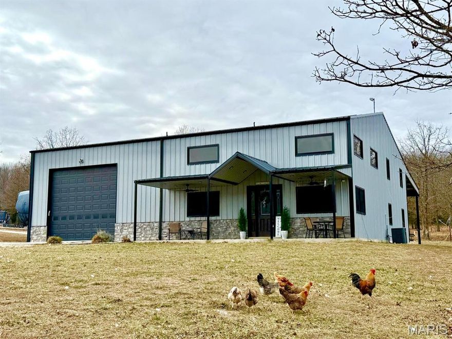 Discover the peace and privacy of country living in Bucyrus, Missouri, just a short 10 minute drive to town. Down a pretty, wooded private drive, the property is 38 acres +/- of gorgeous park-like setting, fresh air and the freedom of rural life. The extremely well-built barndominium style home features 5 bedrooms, 3 1/2 baths and nearly 2600 sq ft of living space on 2 levels. Constructed of steel beams, metal exterior frame and wood interior frame with 8' spray foam insulation, this home was built to stand the test of time. From the covered front porch you step into a great room with soaring ceilings and lots of natural light. Large kitchen with custom cabinets, an abundance of counter space and a walk-in pantry to please any cooks heart. The main level offers a master suite with a walk-in tile shower and very generous walk-in closet, additional bedroom, half bath for guests and large utility room with built in wooden lockers for convenience. Upstairs you will find a 2nd living room, master bedroom with en-suite bath, 2 additional bedrooms and full bath. Fully floored attic space for additional storage, too. From the main level utility room you can access the attached 32 x 54 heated shop with overhead door and pit drain for added convenience. An attached 22 x 64 lean-to off the rear provides plenty of parking or customizable to your needs. A year round spring fed creek, freshly cleaned out and enlarged pond just waiting on spring rains to finish filling up, and perimeter fencing makes this the ideal Ozarks full-time residence or a peaceful retreat. Perfect for multi-generational housing, homesteading, or home-based business. Located 10 minutes to the conveniences of town, near local rivers, and 1000's of acres of National Forest Land for outdoor enjoyment.