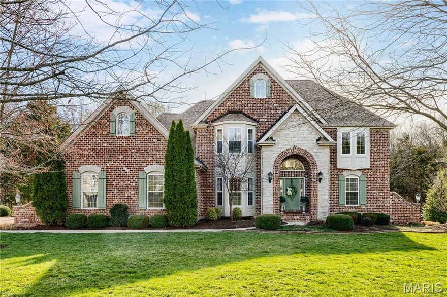 Spectacular brick & stone 1.5-Sty on wooded 3-acre lot in beautiful August Estates. Impressive 2-sty foyer leads to coffered dining room with wide bay window & arched entryway framed by architectural columns and stunning great room with dramatic wall of windows & granite fireplace.  Designer kitchen with staggered white cabinetry, granite countertops, stainless steel appliances & 7’ center island adjoins breakfast room with convenient planning center & vaulted hearth room highlighted by floor-to-ceiling stone fireplace. Coffered primary bedroom suite with luxury bath offers an appealing retreat. Oak staircase accesses 3 additional bedrooms, 1 with ensuite bath & 2 with Jack n’ Jill bath, & bonus loft room. Lower Level entertainment space includes recreation room with wet bar, family room with 3rd fireplace & game room plus workout room, 5th bedroom & full bath. Atrium doors open to outdoor living area with pool, composite deck, covered patio & open patio with full-height fireplace.