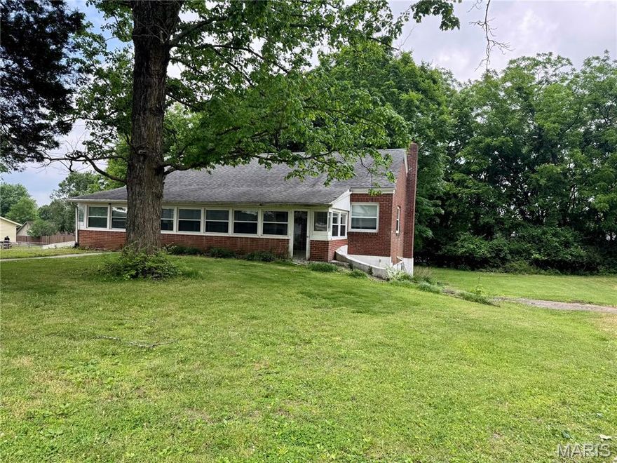 Charming all brick cottage sitting on .44 acres with a private drive in Alma Schrader Elementary district. Large living room with wood floors. Updated bathroom will all tile shower. Features 10 by 36 sunporch and newer windows on the main. Could have 2 main floor bedrooms, but would have to walk through one to get to the other. The large finished area in the basement is a legal bedroom or could be a second living area.