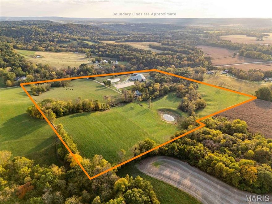 Welcome to your dream equestrian property in Pike County, Missouri!  This meticulously planned equestrian property encompasses 45 acres of mixed-use land, featuring woods, fenced pastures, and hayfields. Improvements include a custom log house, detached garage (with additional living quarters), horse barn with indoor arena, outdoor arena with turnouts, and a shed. The log home is a unique gem, featuring a main-level primary suite complete with a walk-in custom closet, a soaking tub, and heated floor in the bathroom. The main level boasts a gas fireplace, a half bath, a mud room with heated floor, and a tongue-and-groove ceiling. The kitchen is equipped with an island, propane range, dishwasher, and a walk-in pantry. All appliances will convey with the sale. Adjacent to the main level, is a large deck with a spectacular view, fireplace and a bar, perfect for entertaining! The walk-out basement offers a cozy retreat with a laundry room and two bedrooms, one of which is a non-conforming space that can serve a variety of purposes. Additionally, it boasts a man cave, complete with a wood stove. The upper-level open loft overlooks the main living area. It includes a closet and a bathroom with a shower, making it suitable for a guest room or an office. The detached two-car garage, conveniently situated beside the home, has three-quarter bathroom on the main level for added convenience. The upper level has tongue-and-groove paneling that creates a warm and inviting atmosphere. This space also includes a closet, making it an ideal retreat for visitors. The property features a beautifully landscaped yard, with vibrant plants and greenery. It boasts an array of mature fruit trees, providing a delightful harvest of fruits throughout the seasons as well as a newly constructed pond and an existing pond. This property boasts a prime location, situated a mere 35 minutes from the renowned Bridlespur Hunt Club, and, is only 1 hour away from the acclaimed National Equestrian Center.  This strategic positioning allows for easy access to premier equestrian facilities while still providing the tranquility and charm of rural living.