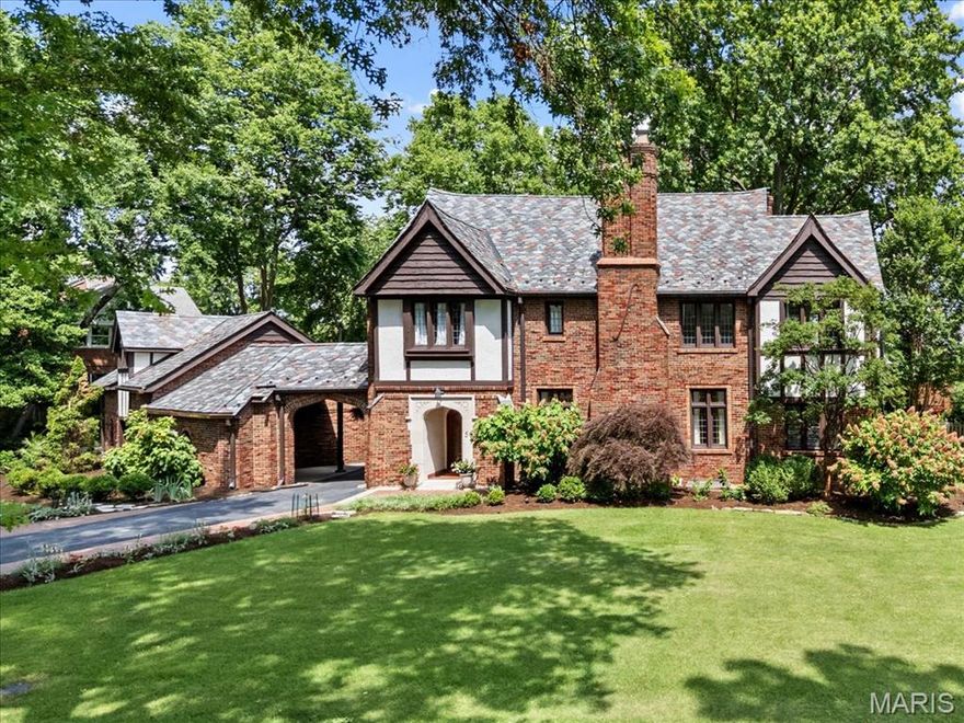 Welcome to this magnificent Tudor-style residence in the heart of Clayton’s coveted Claverach Park. This 6-bedroom, 4.5-bath home blends timeless architecture with modern luxury across 4,045+ square feet of beautifully finished living space. Situated on a generous, level lot with mature trees, the property offers both privacy and presence. Inside, you’ll find soaring ceilings, refined millwork, and a bright, open floor plan ideal for everyday living and elegant entertaining. The heart of the home is the chef’s kitchen—thoughtfully updated with premium finishes, ample cabinetry, and generous prep space. The stunning living room features a dramatic stone fireplace and oversized windows, while the adjacent family room boasts custom built-ins, bright exposures, and French doors opening to a covered walk-out patio—perfect for entertaining. Upstairs, four spacious bedrooms include a serene primary suite with a spa-inspired en-suite bath. The finished third floor offers two additional bedrooms with a Jack-and-Jill bathroom, perfect for guests, teens, or home offices. The lower level provides even more space to relax and play, with a finished rec room, full bath, and a custom bar. Additional features include a three-car garage with covered portico, updated systems throughout, gleaming hardwood floors, and exquisite architectural details. Classic charm, modern updates, and an unbeatable Clayton location—this is a rare opportunity to own a true gem in Claverach Park.