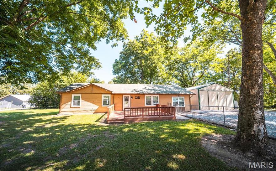 Tucked away on a quiet dead-end street at the edge of town, this beautifully updated 3-bed, 1.5-bath home offers privacy, comfort & a long list of modern upgrades. Surrounded by mature trees & a well-established lawn, the fully fenced property provides a peaceful setting perfect for relaxing or entertaining. Inside, you’ll find a warm & welcoming interior featuring newer doors & windows throughout, new carpet in the bedrooms & luxury touches like hickory kitchen cabinets, updated countertops & a granite sink. The bathrooms have been tastefully renovated with new toilets & a custom tile shower. Other improvements include a new A/C unit, a 50-gallon water heater, updated sewer pipes & a new refrigerator—making this home truly move-in ready. Outdoor living is just as impressive, with a large front deck for entertaining, a smaller back deck for quiet moments, and two outbuildings—a 10x12 aluminum shed & a 12x12 wood shed for additional storage. But the real showstopper is the 20x44 fully insulated workshop—an ideal space for hobbyists, mechanics, or small business owners. This well-equipped workshop features A/C, 220-amp service, multiple outlets, new LED lighting, cable/internet hookups, a new heater & a ceiling-mounted winch—offering unmatched versatility & functionality. With so many thoughtful upgrades & valuable features throughout, this home is a rare find that combines small-town serenity with modern amenities & exceptional workspace potential.