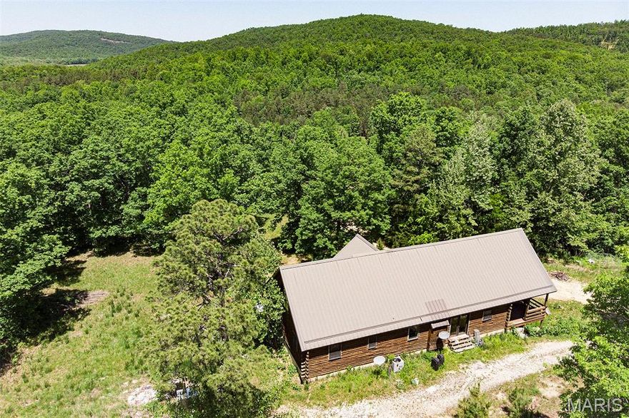 Rustic charm meets modern comfort at this beautiful log cabin retreat nestled on 10.56 acres in the scenic Lesterville area. This 2 bedroom, 3 bath home offers an inviting open floor plan with warm wood finishes, soaring ceilings, and plenty of natural light. Spacious master suite provides a private escape, while the unfinished loft offers endless potential for additional living space, office, or guest quarters. Full 9-ft poured walk-out basement is partially finished and ready for your personal touch—ideal for recreation space, storage, or expansion. Enjoy the peace and privacy of acreage living with room to roam, hunt, garden, or simply relax and take in the natural surroundings. Conveniently located just minutes from the Black River and Tom Sauk Lake for floating, fishing, boating, and outdoor adventure. A rare opportunity to own a true Missouri log cabin getaway with space, privacy, and potential!