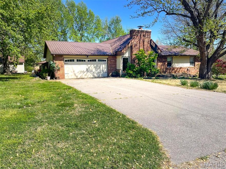 Escape the hustle & bustle and enjoy peaceful country living in this charming rustic brick home nestled on approx 1.8 acres that looks like your very own park! This beautiful property features a spacious one level home, 2 car attached garage, storage bldg, & a large inground pool & pool house!
Extra's include...Open layout in main living area / Gorgeous rock wood burning fireplace, Vaulted ceiling with exposed beams / French doors open to a nice sunroom / Kitchen offers a solid surface counter top, range, dishwasher & microwave, just steps away is a utility closet & pantry / Wide hall / Hall bath offers tub shower with custom ceramic surround & dbl vanities / Spacious owners bedroom with an attached private bathroom / Central heat (heat pump) & air new, water heater new 2017 / Thermopane windows / Covered deck / Metal roof / 2 car attached garage / Front yard is irrigated / Detached 10x25 storage bldg / Inground pool 20x40 / Charming pool shed equipped with a changing area & half bath