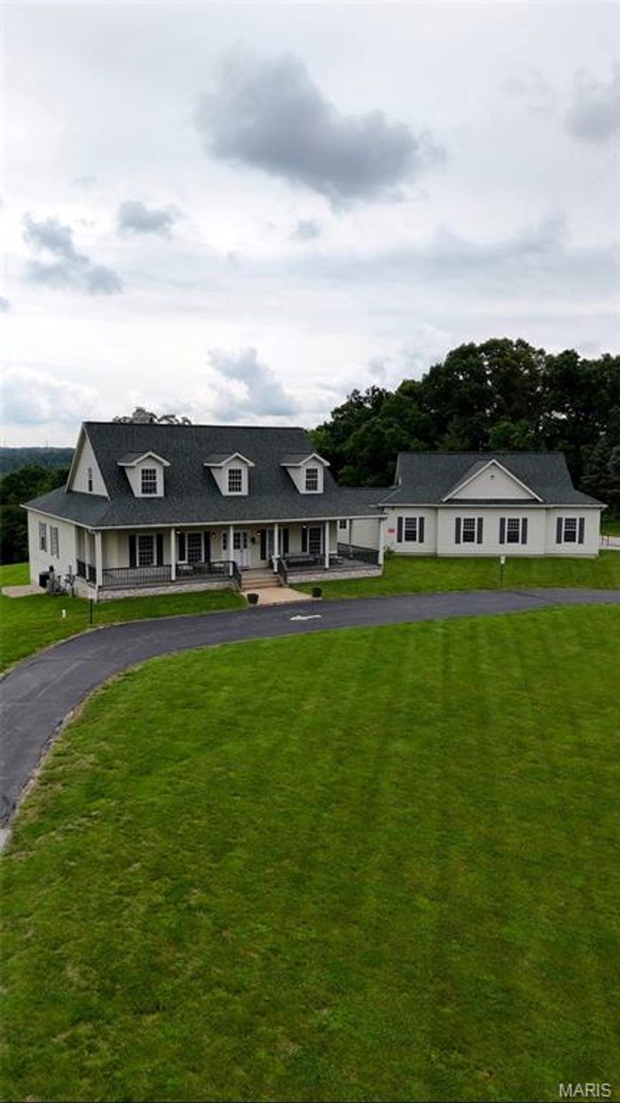 This magnificent house sits on almost 15 acres of beautiful land.  This expansive property offers a private setting allowing for stunning panoramic views.  The residence features over 5000 sq ft of total living area that caters to a variety of living arrangements.  The main level has soaring 10 ft ceilings, two bedrooms, a large kitchen, great room with a stone fireplace and an eating area with three walls of windows.  The lower-level walk out is also accessible from a wide sidewalk with handrail and is highlighted by a bedroom, rec room and additional stone fireplace.  The outdoor living is equally impressive with a large, covered porch and deck that invite you to relax and enjoy the peaceful surroundings.  There is also paved parking for up to 10 cars that is ADA accessible.