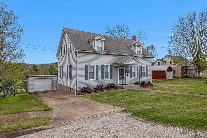 Turn-key guesthouse opportunity in the heart of Hermann! This 4-bedroom, 2-bath property is perfectly set up for immediate use as an income-producing rental or a comfortable getaway for owners and guests alike. Inside, you’ll find warm wood floors and a spacious layout featuring a full-size living room, dining room, and kitchen ideal for hosting families and groups. The home offers plenty of room to gather, relax, and enjoy everything Hermann has to offer. Step out onto the back porch and take in peaceful views overlooking Hermann City Park, creating a serene setting for morning coffee or evening unwinding. A detached garage adds convenience and extra storage. Located just a couple of blocks from downtown Hermann, guests can easily walk to local shops, restaurants, wineries, and attractions while still enjoying a quiet setting near the park. Whether you're looking to expand your investment portfolio or own a guesthouse for personal use, this property offers both charm and strong rental potential.
