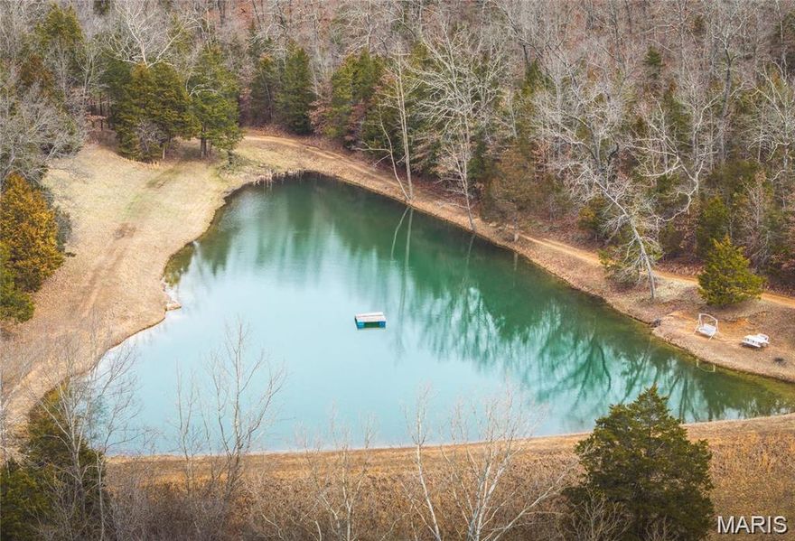 46.5 PRIVATE acres + Mobile home 1386 sq ft + 40 x 48 Shop + Spring fed Lake!  Build your dream home on the edge of the lake with ALL the views & use the mobile home as rental income or however you want to do it. This place has so many possibilities!  The acreage has woods for hunting, approx 8 acres cleared for hay or pasture, a big spring fed lake & 2 other springs on the property.  The mobile home was built in 2006.  3BR/2BA w/double carport. Spacious walk in closets in all bedrooms, 2 x 6 walls & extra insulation, all electric & sitting on a concrete pad.  It has its own well & septic & 2 Storage sheds/outbuildings.  The Shop was built in 2013 & measures 40 x 48 & 11 ft high.  It has a lean to added on the back that gives lots of extra space 40 x 12 x 12 high.  There is also an RV/camper carport that is 40 x 8 x 14 high.  Shop & Carport have electric, lighting, & available water. The views are gorgeous. Complete with a wet weather creek & park like setting! This is your private place in the country w/ everything you could ask for!  This property is also listed under the Farm category-MLS # 25062202 Come check out your next BIG move!