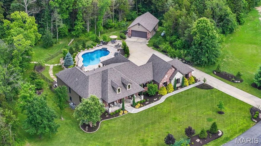 UNDER CONTRACT—OPEN HOUSE CANCELLED! Stunning custom ranch with inground pool and detached garage nestled on a 6+ acre wooded lot just a few minutes from highway 70. You have to SEE in person to appreciate the level of updates in this spectacular home. No expense was spared when this home was redesigned by Savvy Design Group and renovated by Markway Construction. Updates and upgrades to this home include a complete kitchen redesign with Cambria countertops, sleek stainless appliances, custom cabinetry, and stunning fixtures. Great room fireplace with lighted built-ins and a wall of windows overlooking the pool & wooded private lot. Updated lighting & chandeliers throughout, high-end drapery by Sunshine Drapery, and walk-in closets designed & created by Closet Factory. This unique floor plan features two primary suites on the main level, each with a private full bath and custom closet. Professionally finished and redesigned lower level is color-drenched and evokes a moody vibe complete with library, coffee bar, office, bedroom and full bath, yet there's still plenty of unfinished space for an added potential theater room. Hard-wired hot tub, outdoor fireplace with patio and covered paver patio, extensive landscape designed by Frisella, upgraded/newer irrigation and epoxy finished garage floors. This one honestly must be seen in person to appreciate the exquisite design choices and private setting.